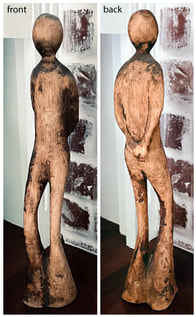 wood sculpture of standing figure